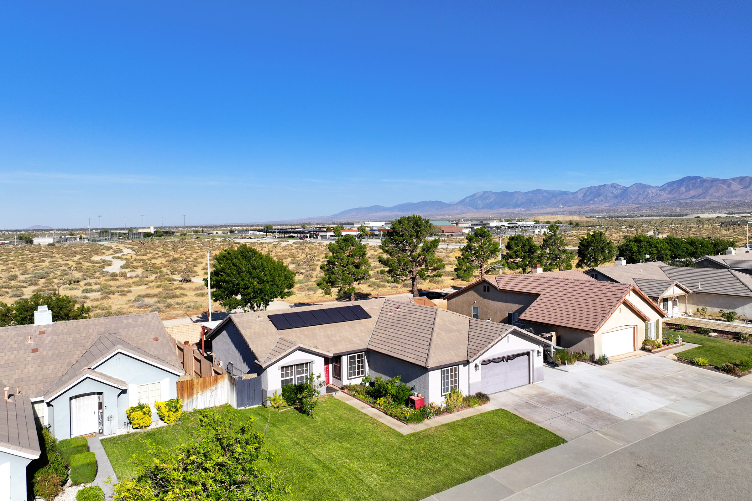 Aerial view of an Antelope Valley neighborhood with desert and mountains in the distance